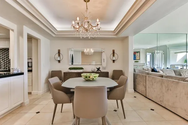 a view of a dining room with furniture and a chandelier
