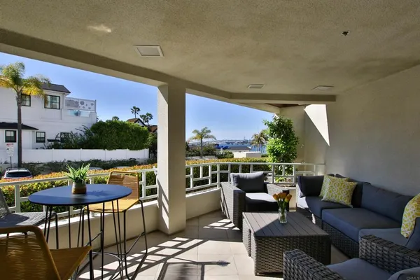 a balcony with furniture and rug