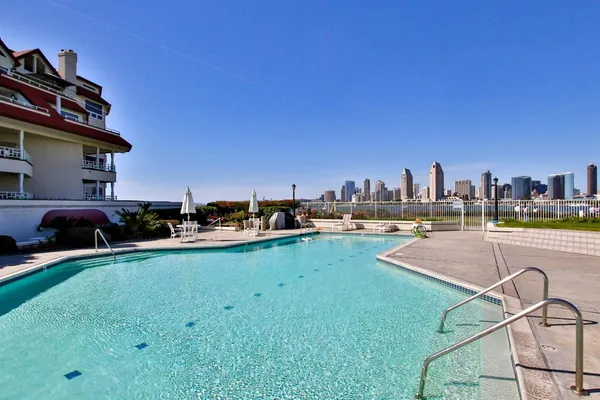 a view of a swimming pool and a back yard