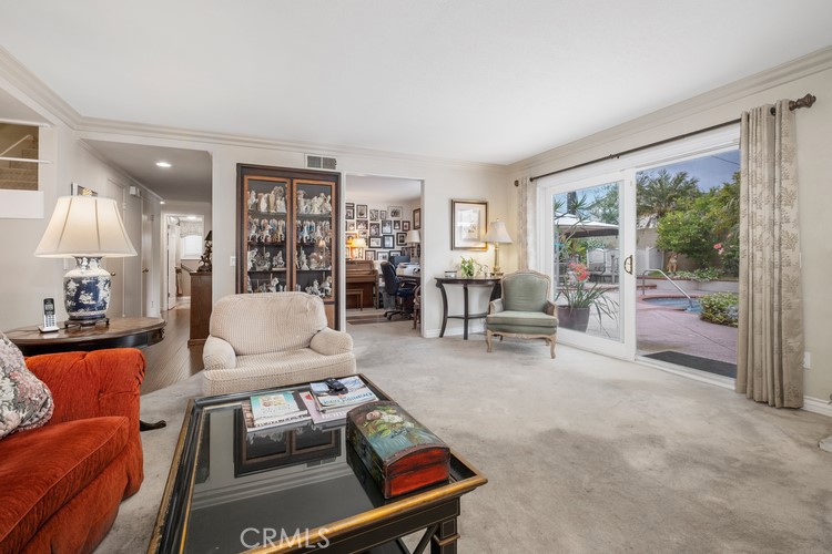 9331 Cape Cod Drive Huntington Beach, CA 92646 - Photo 11 of 31 a living room with furniture and a floor to ceiling window