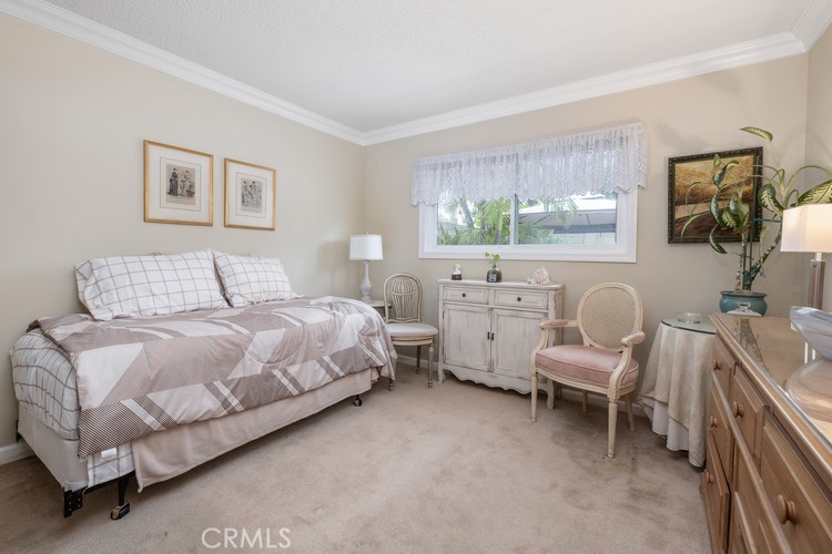 9331 Cape Cod Drive Huntington Beach, CA 92646 - Photo 15 of 31 a bedroom with a bed and a couch