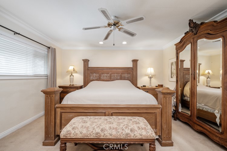 9331 Cape Cod Drive Huntington Beach, CA 92646 - Photo 16 of 31 a bed sitting in a bedroom next to a window