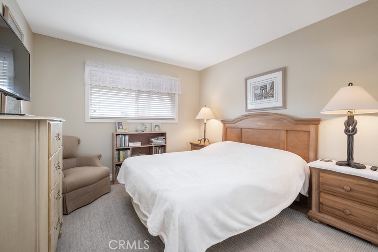 9331 Cape Cod Drive Huntington Beach, CA 92646 - Photo 22 of 31 a bedroom with a bed and a lamp
