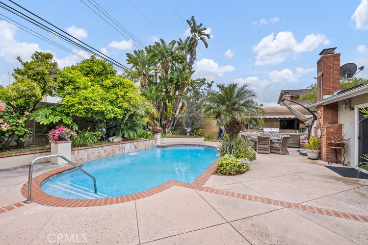 9331 Cape Cod Drive Huntington Beach, CA 92646 - Photo 24 of 31 a vase of flowers sitting on a floor in front of a house