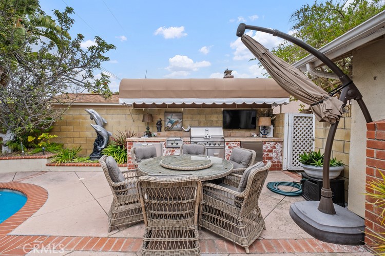 9331 Cape Cod Drive Huntington Beach, CA 92646 - Photo 30 of 31 a view of a patio with couches table and chairs and potted plants