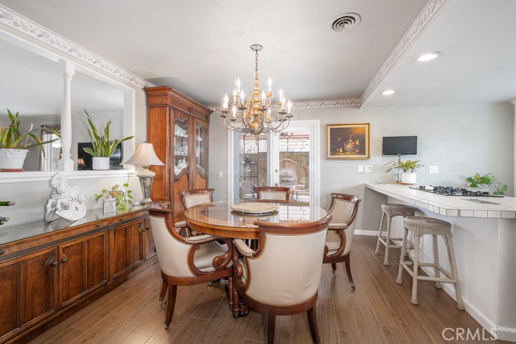 9331 Cape Cod Drive Huntington Beach, CA 92646 - Photo 5 of 31 a view of a dining room with furniture a chandelier and wooden floor