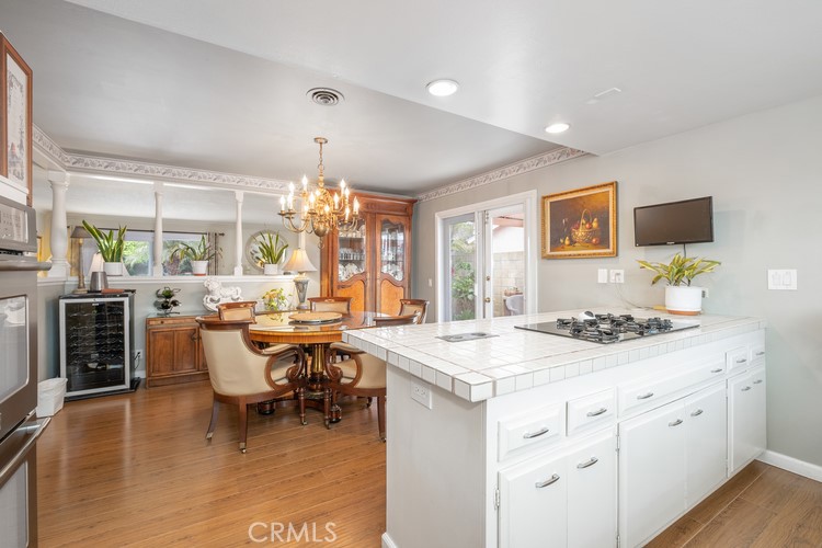 9331 Cape Cod Drive Huntington Beach, CA 92646 - Photo 8 of 31 a view of dining table chairs and wooden floor