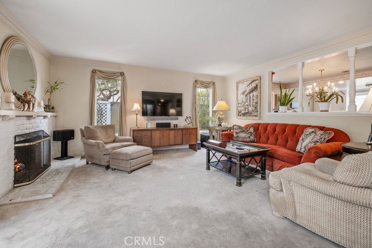 9331 Cape Cod Drive Huntington Beach, CA 92646 - Photo 10 of 31 a living room with furniture and a flat screen tv