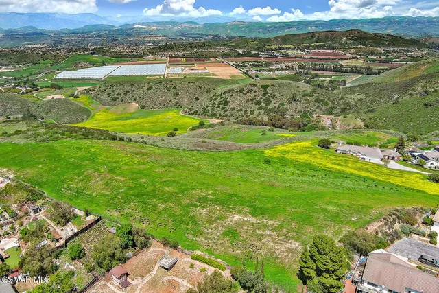 an aerial view of a houses with a yard