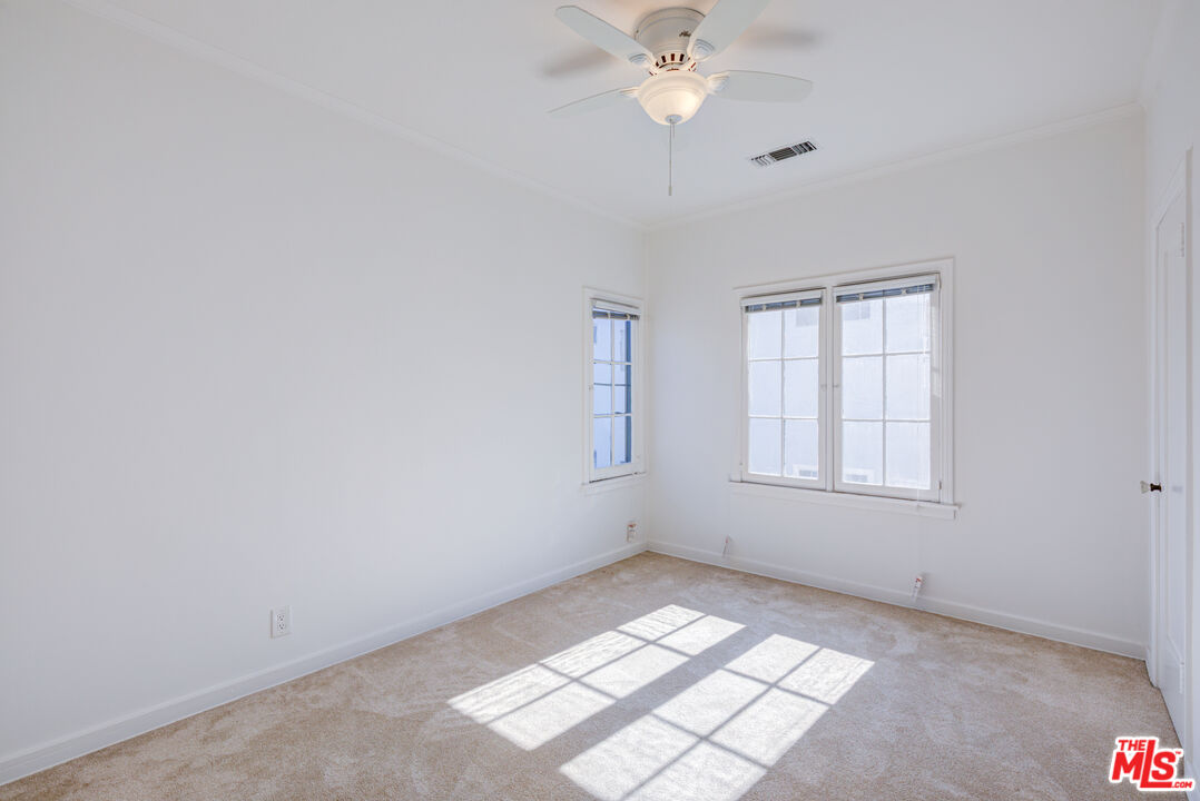 1447 North Vista Street, Unit 1/2 Los Angeles, CA 90046 - Photo 19 of 23 an empty room with windows and fan