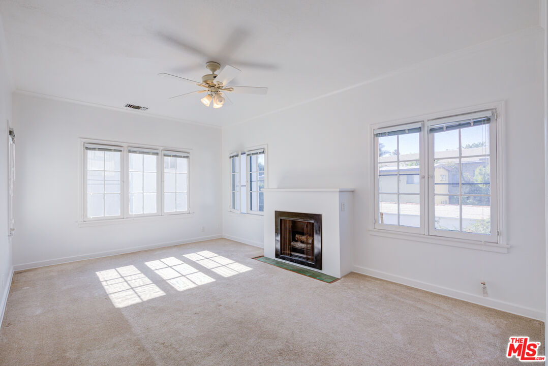 1447 North Vista Street, Unit 1/2 Los Angeles, CA 90046 - Photo 6 of 23 an empty room with windows and fireplace