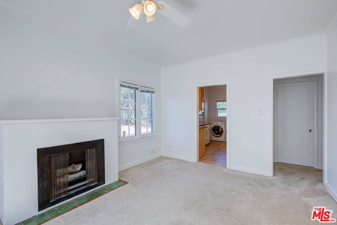 1447 North Vista Street, Unit 1/2 Los Angeles, CA 90046 - Photo 8 of 23 a view of an empty room with a fireplace and window