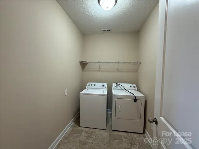 an empty room with windows and ceiling fan