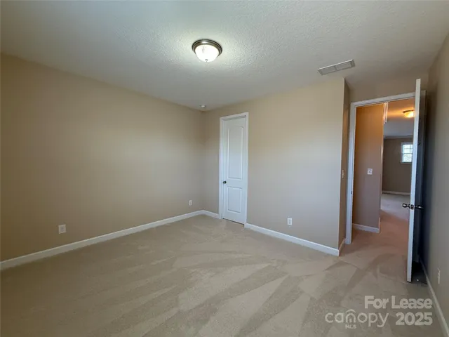 a spacious bathroom with a double vanity sink a large mirror and a shower