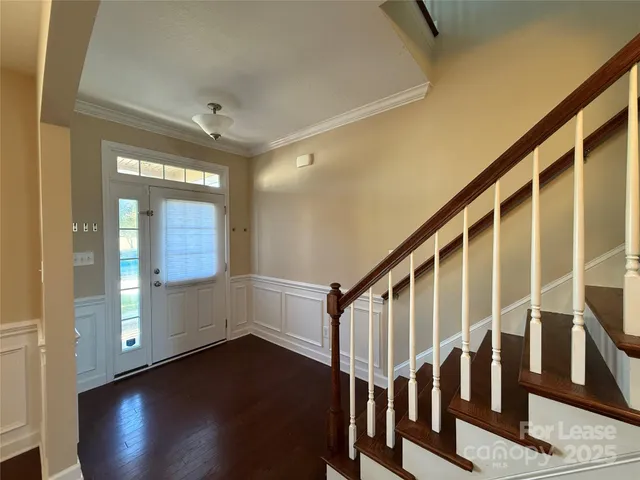 a view of entryway and hall with wooden floor