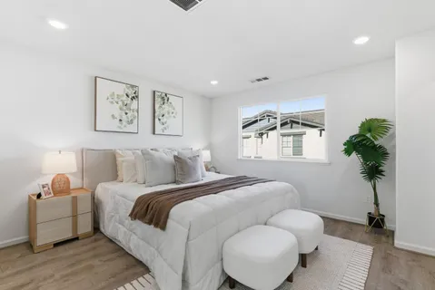 a bed room with bed and a potted plant