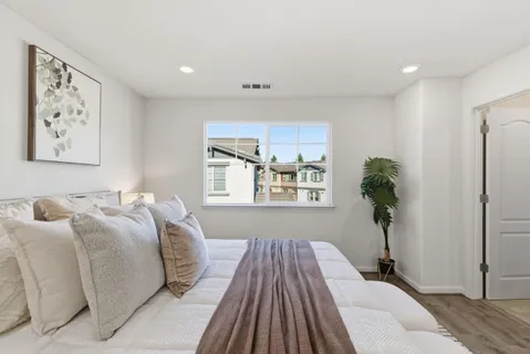a bedroom with a bed and a window