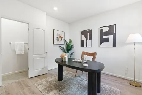 a workspace room with furniture and wooden floor