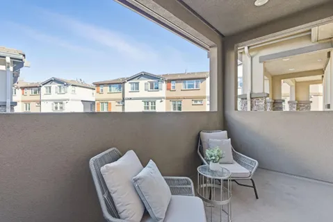 a balcony with table and chairs