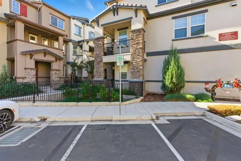 a view of a brick building next to a yard
