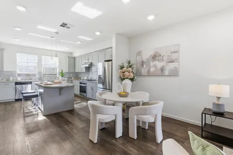 a dining room with furniture and wooden floor