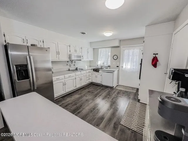 a kitchen with stainless steel appliances granite countertop a refrigerator sink and stove