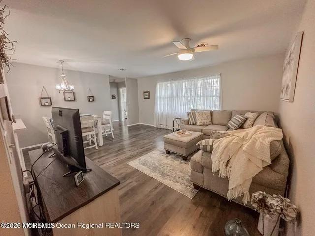 a bedroom with a bed a window and dresser