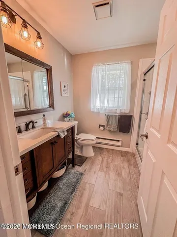 a spacious bathroom with a tub sink and mirror
