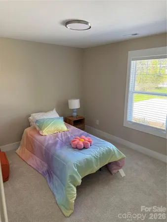 a bedroom with a bed and window