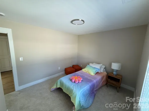 a bedroom with a bed and a table