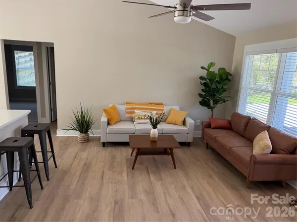 a living room with furniture and a potted plant