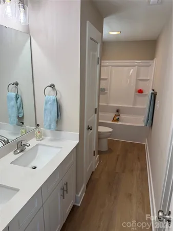 a bathroom with a sink a mirror and a bathtub