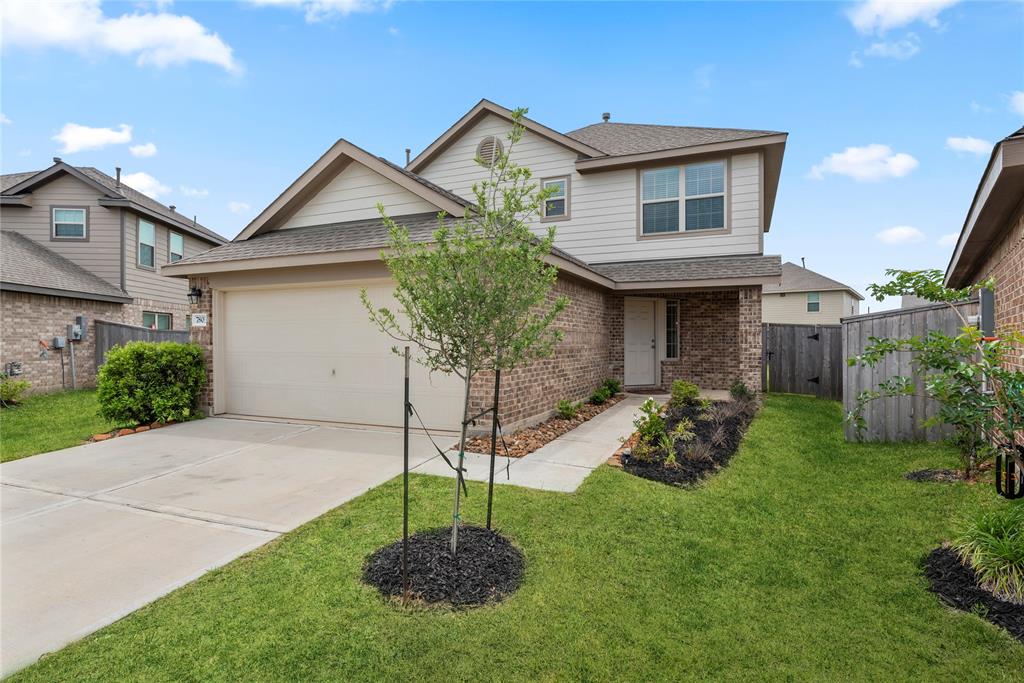 Welcome home to 7803 Winward Ridge Way! The combination of a professionally landscaped pathway and window framing the front door creates a welcoming and elegant entrance.