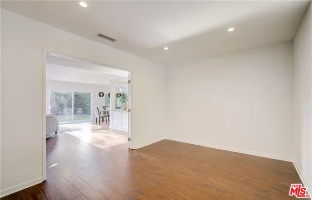 a view of a room with wooden floor and a fireplace