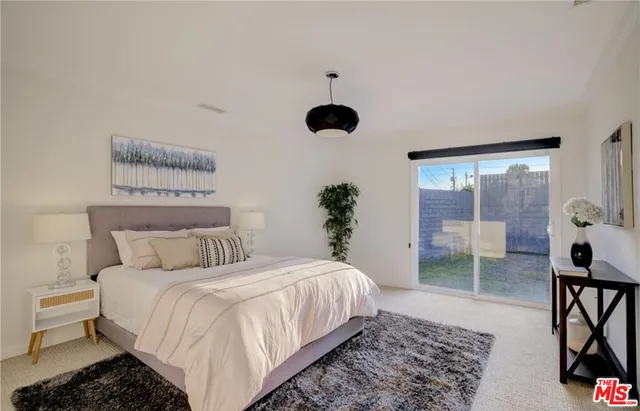 a bedroom with a bed and a large window