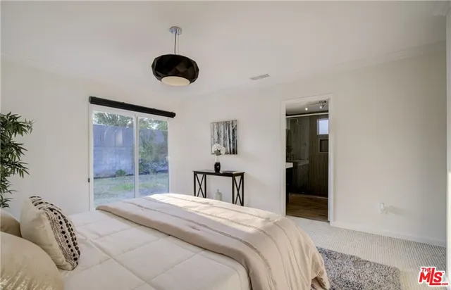 a bedroom with a bed and window