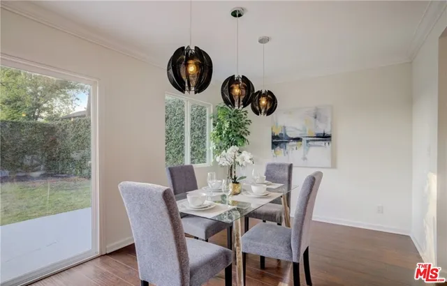 a dining room with furniture garden view and a large window