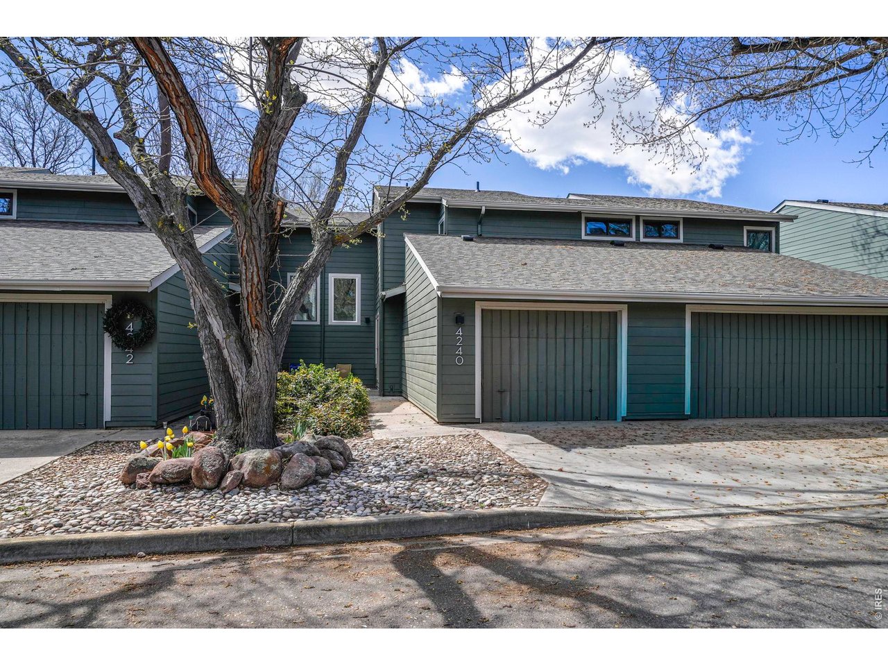 4240 Corriente Place Boulder, CO 80301 - Photo 1 of 21 a front view of a house with a yard and potted plants