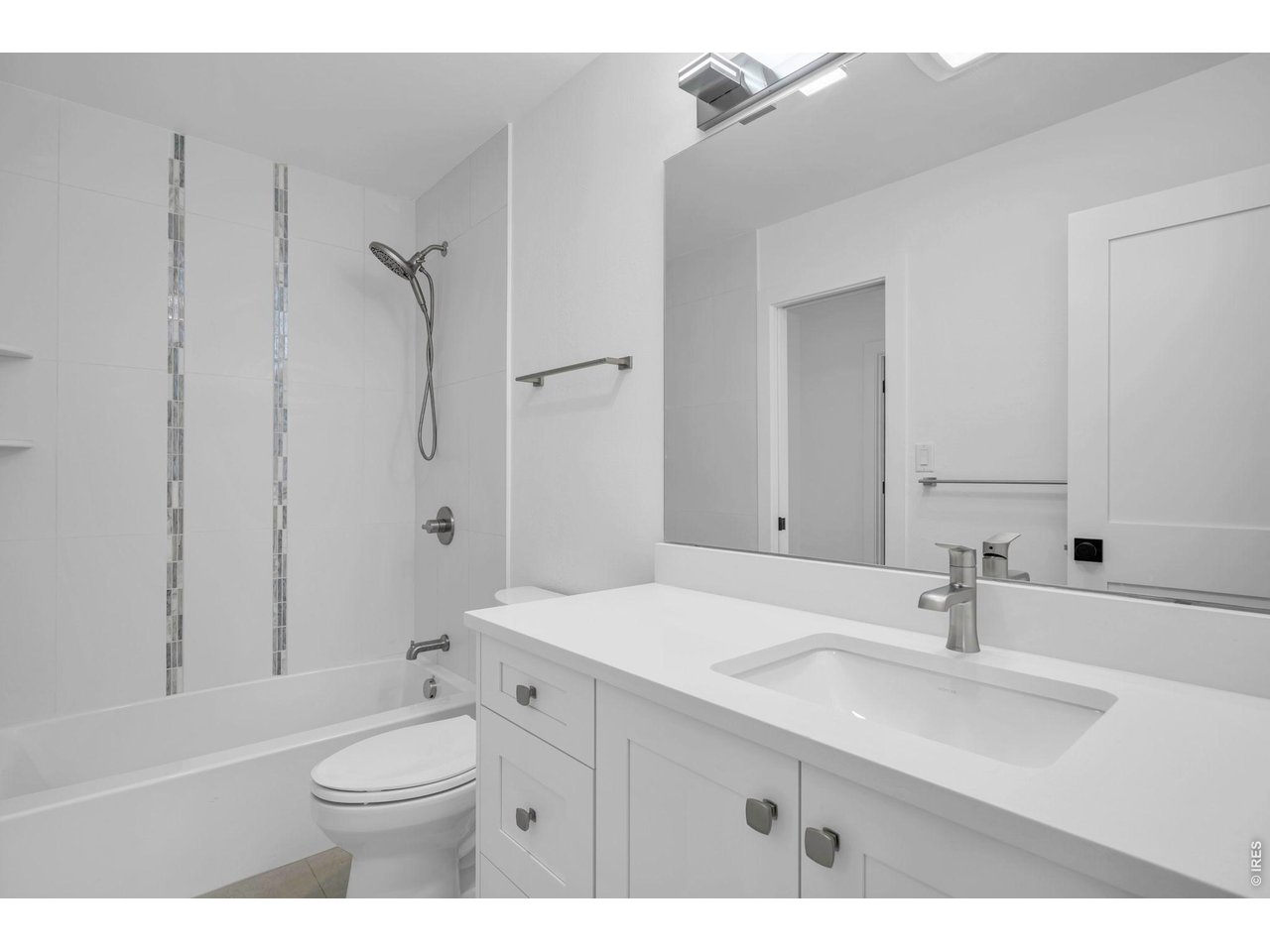 4240 Corriente Place Boulder, CO 80301 - Photo 13 of 21 a bathroom with a sink a toilet a mirror and shower