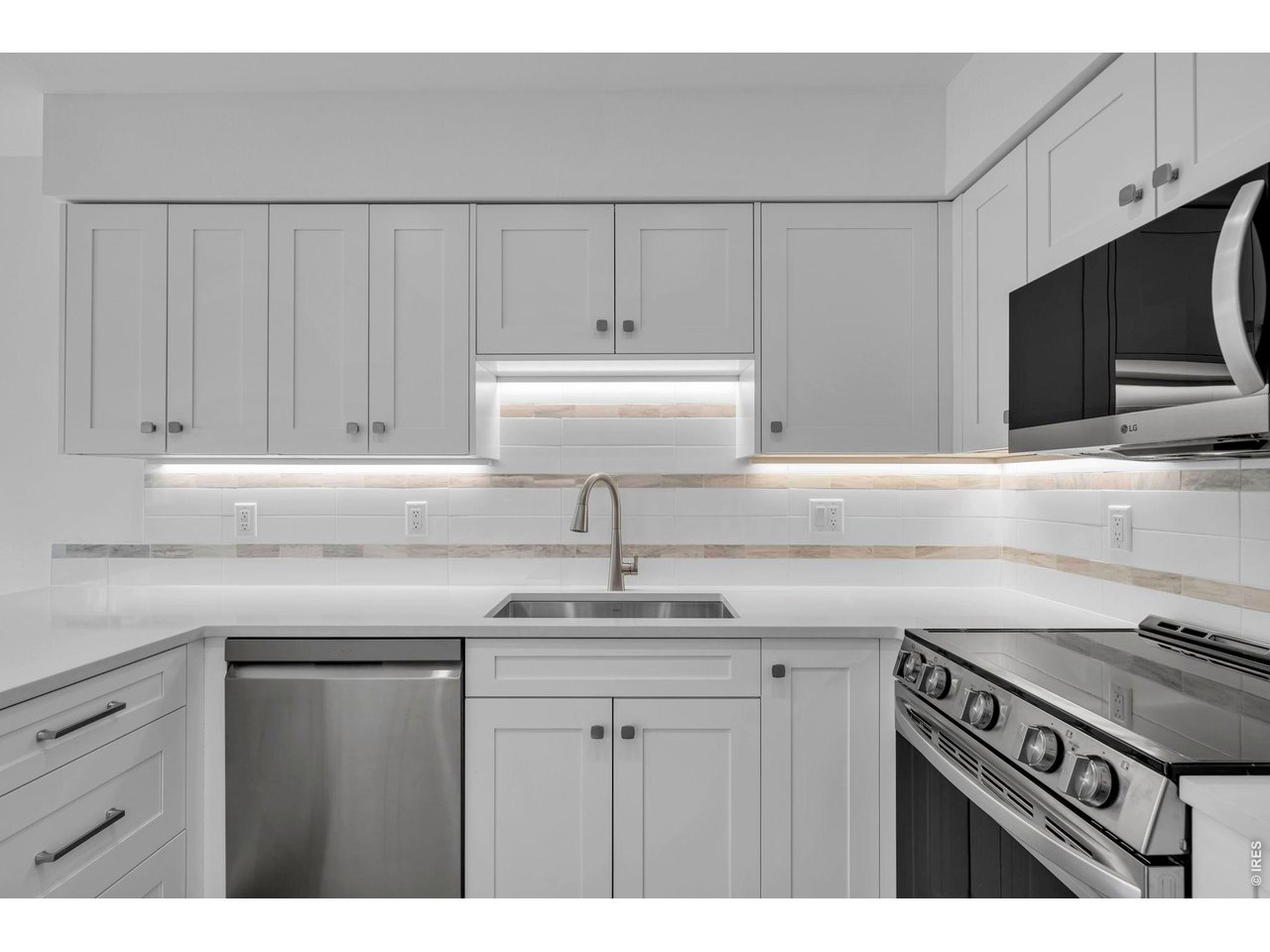 4240 Corriente Place Boulder, CO 80301 - Photo 7 of 21 a kitchen with a sink dishwasher a stove and a microwave oven