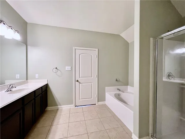 a bathroom with a shower and a glass door