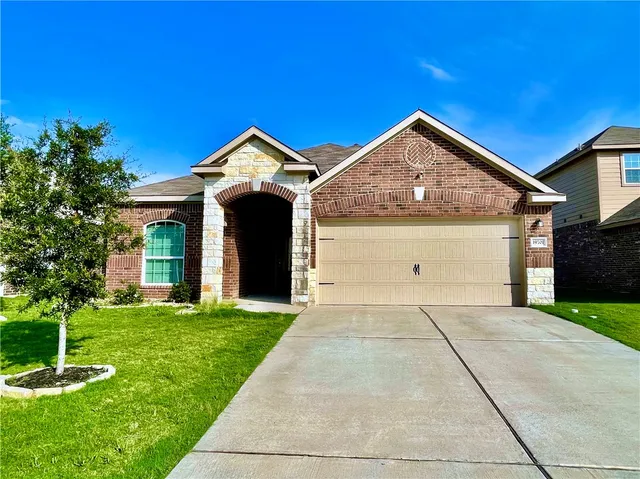 a front view of a house with yard