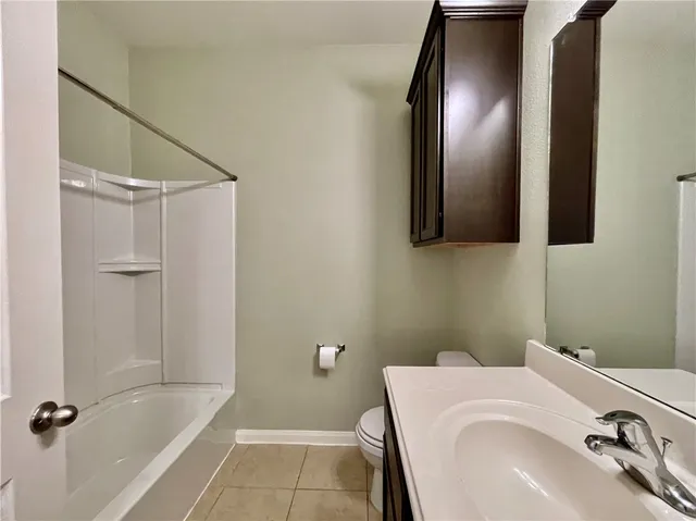 a bathroom with a double vanity sink a shower and a mirror