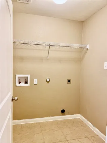 a view of a big house with a big yard and potted plants