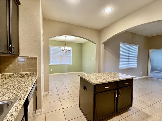 a kitchen with a sink refrigerator and microwave