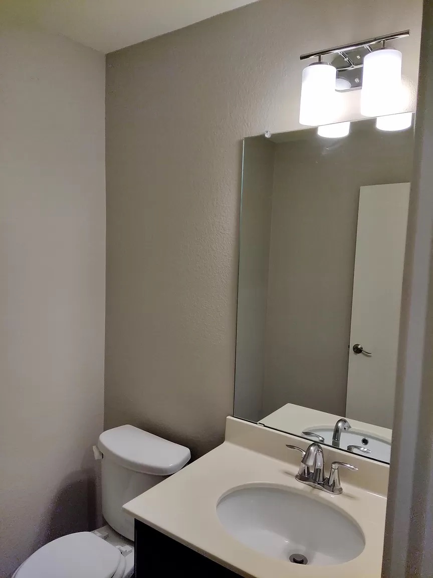 9016 Ridgewell Road Austin, TX 78747 - Photo 17 of 30 Functional full bathroom featuring a vanity with an integrated sink and an adjacent commode.