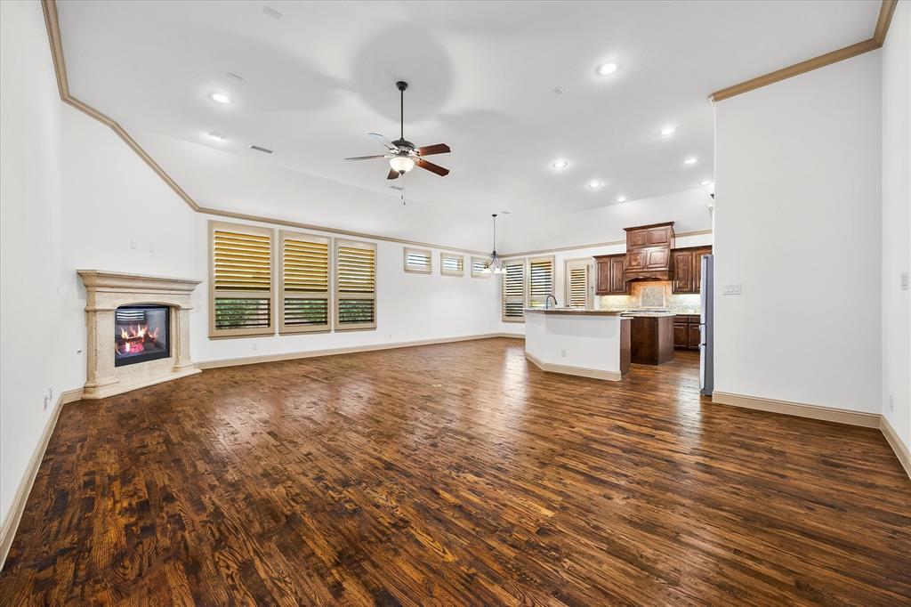 6814 Springwood Lane Garland, TX 75044 - Photo 3 of 35 a view of an empty room with a window and wooden floor