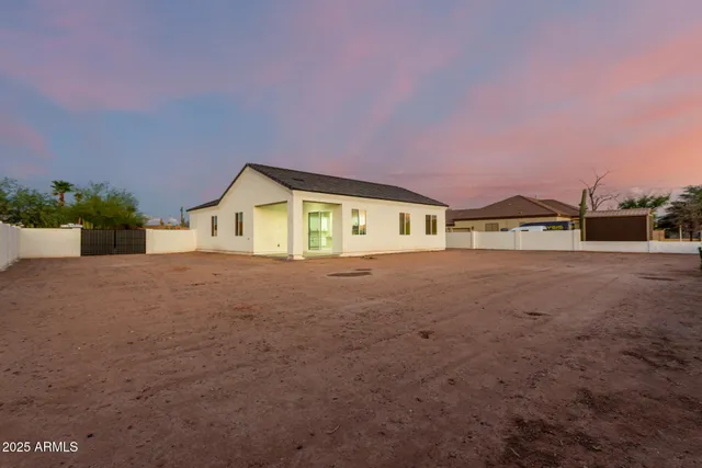 a view of a house with backyard and road