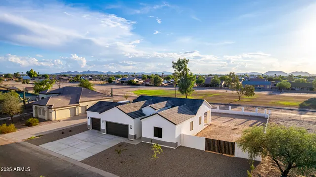 an aerial view of a house with outdoor space and ocean view