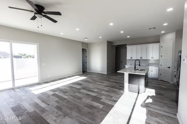 a view of kitchen with sink microwave and cabinets